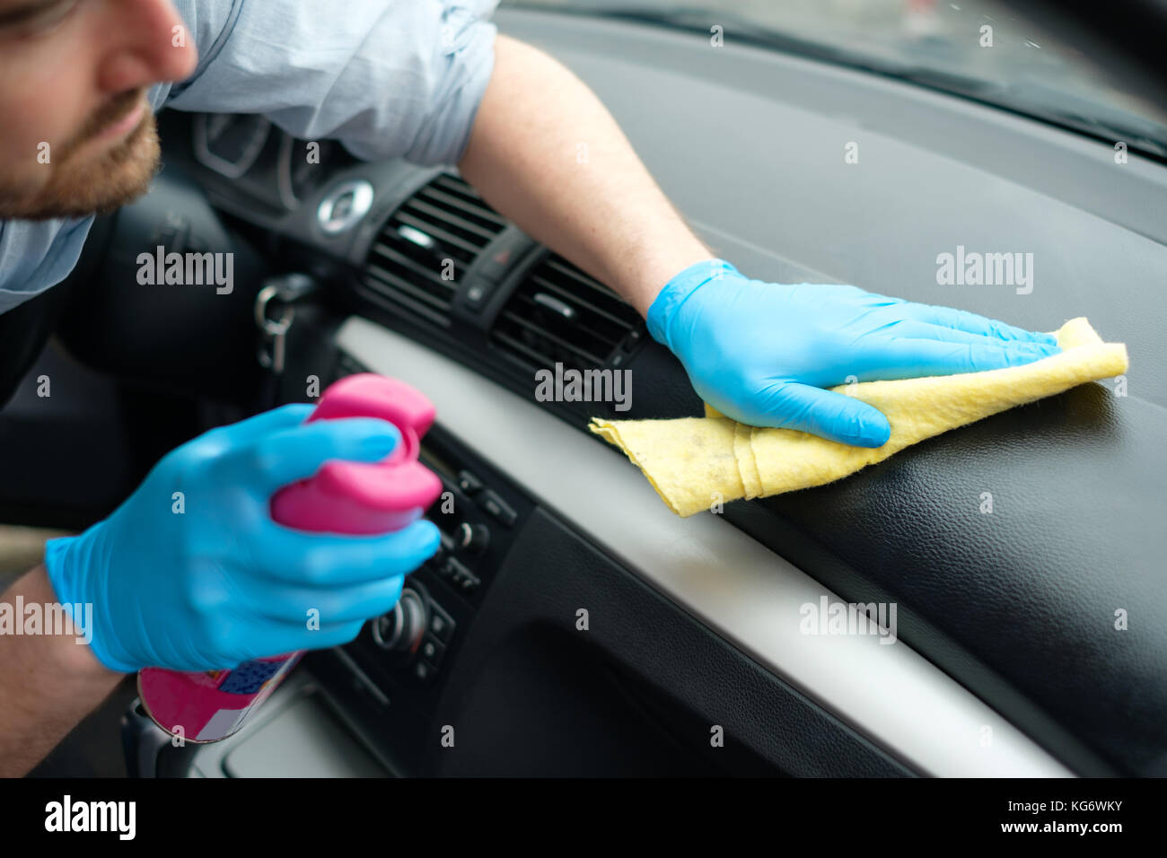 Man Cleaning His Car Interiors And Dashboard Stock Photo