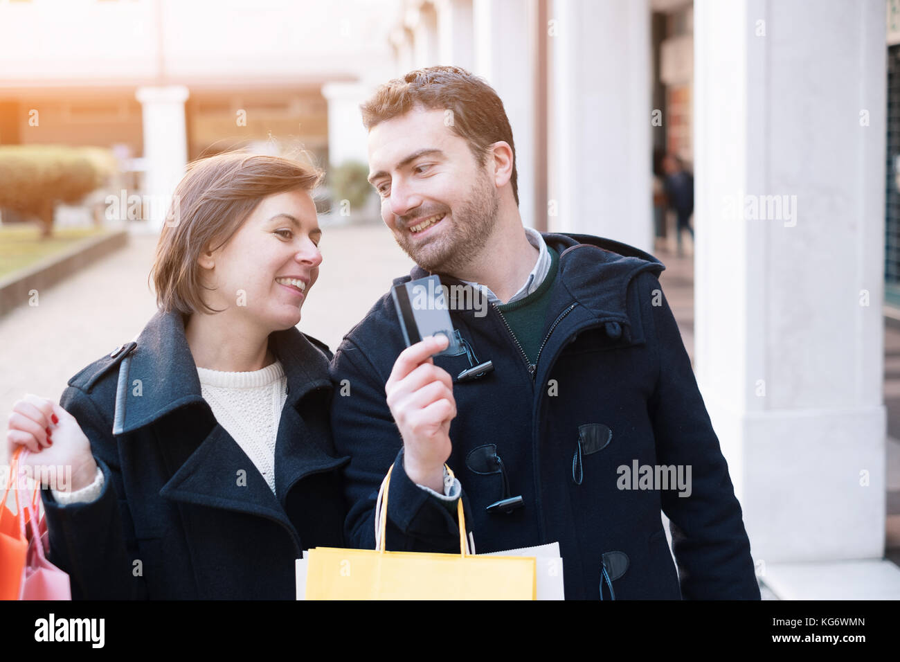 Man holding a credit card ready for the shopping time with his girlfriend Stock Photo