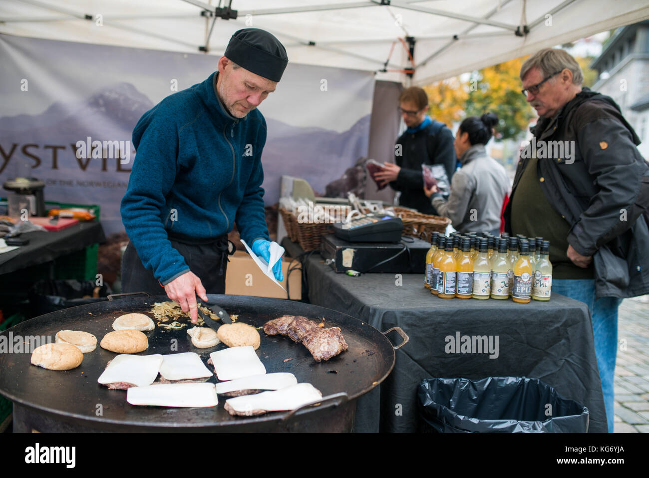 Bergen, Norway -  October 2017 :  Man preparing burgers on the street food market Stock Photo
