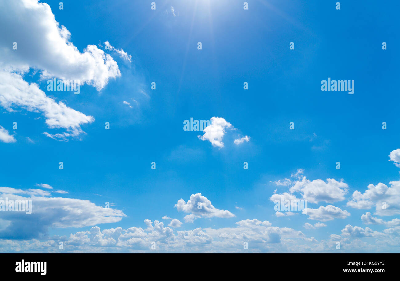 cloudscape with blue sky and sun for backgrounds Stock Photo - Alamy