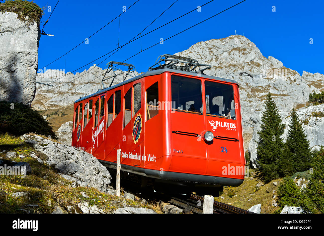 Red railcar of the Pilatus Railway on the way to the top of the Pilatus massif, Alpnachstad, Switzerland Stock Photo