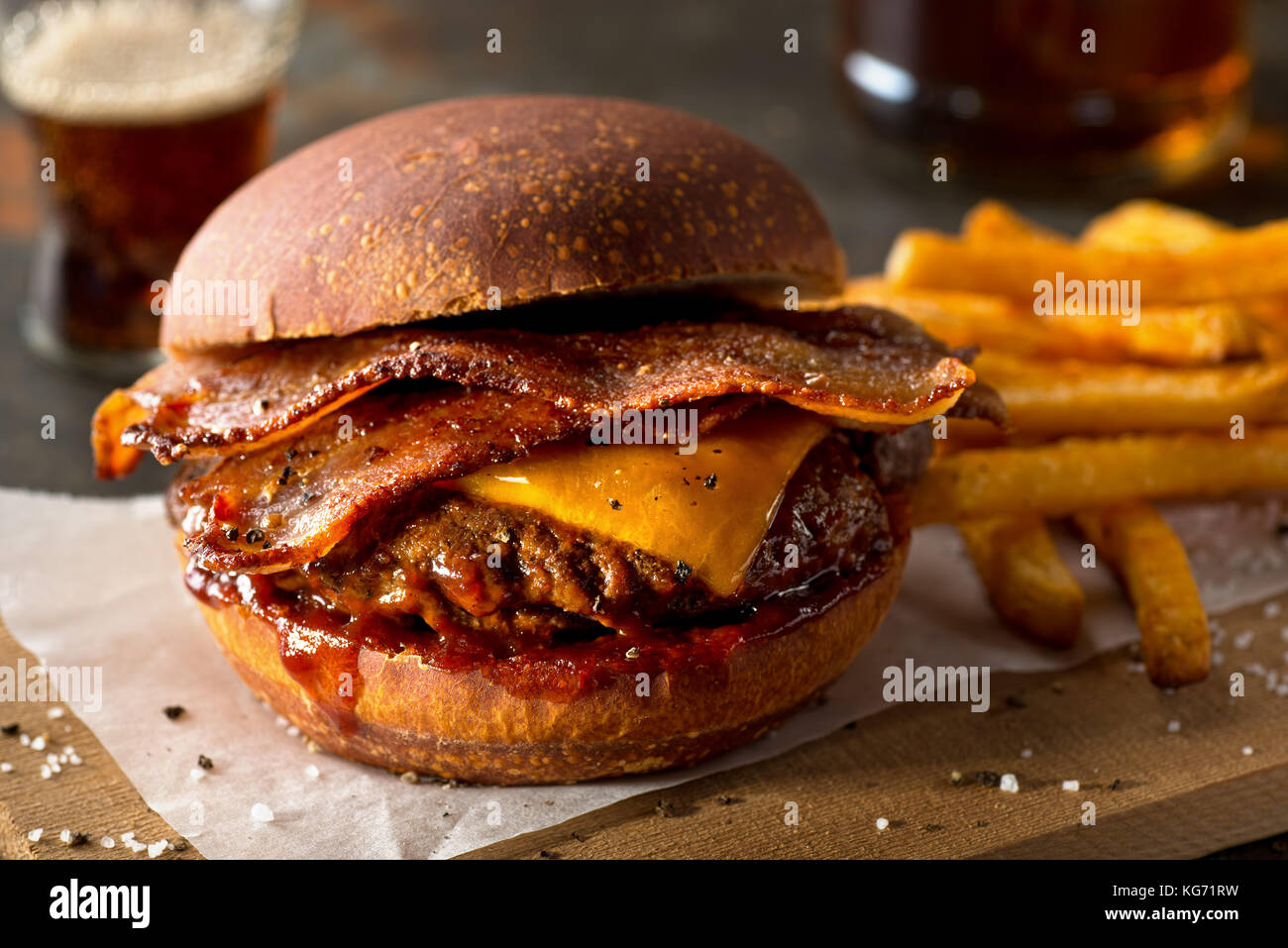 A delicious pub style bacon cheeseburger with barbecue sauce and french