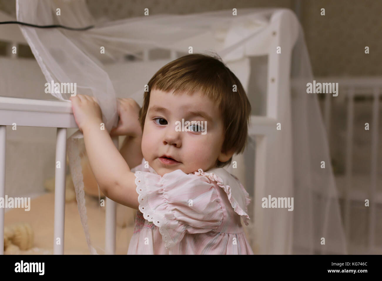 cute little kids on the floor in the interior of a child's room Stock