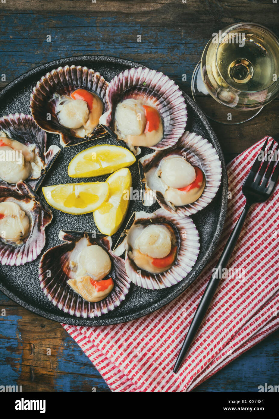 Seafood. Shellfish. Raw scallops with lemon, cilantro and white wine on