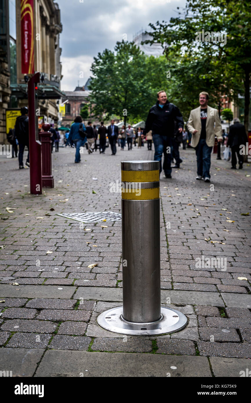 Automatic bollard preventing all but emergency vehicle access to St Ann's Square in Manchester Stock Photo