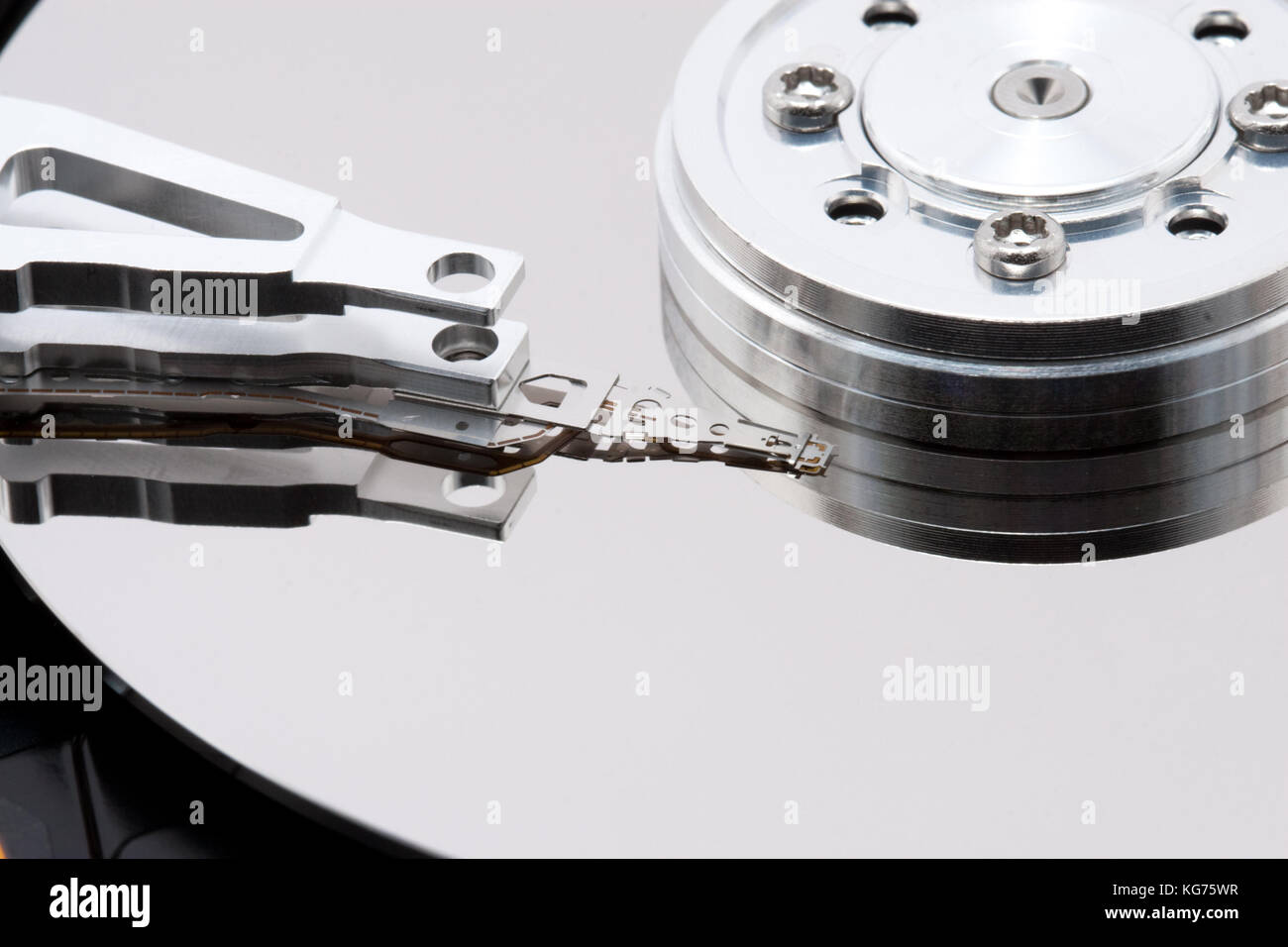 Close up inside of a computer harddrive with reflections of the read ...