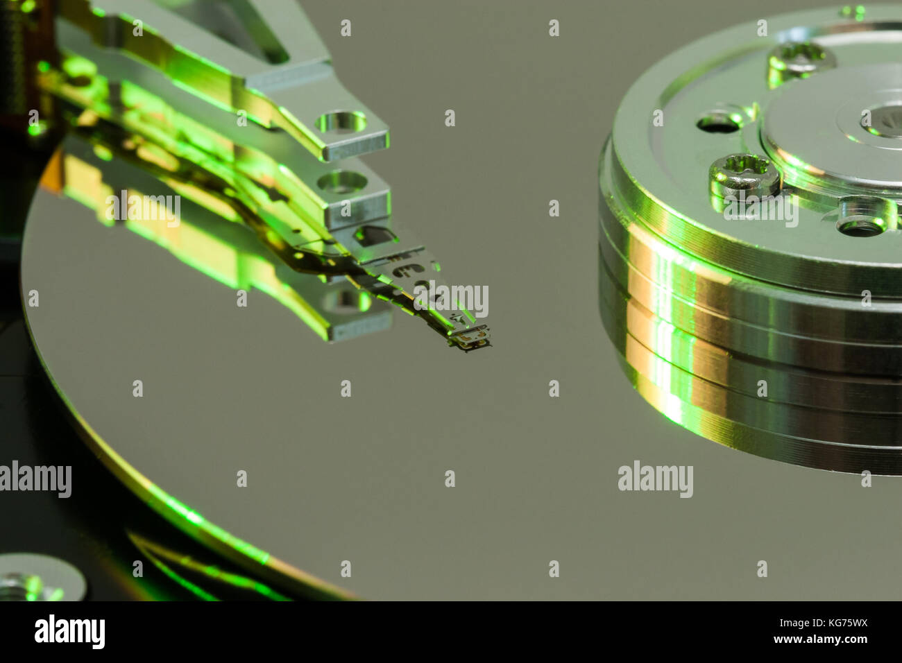 Close up inside of a computer harddrive with reflections of the read ...