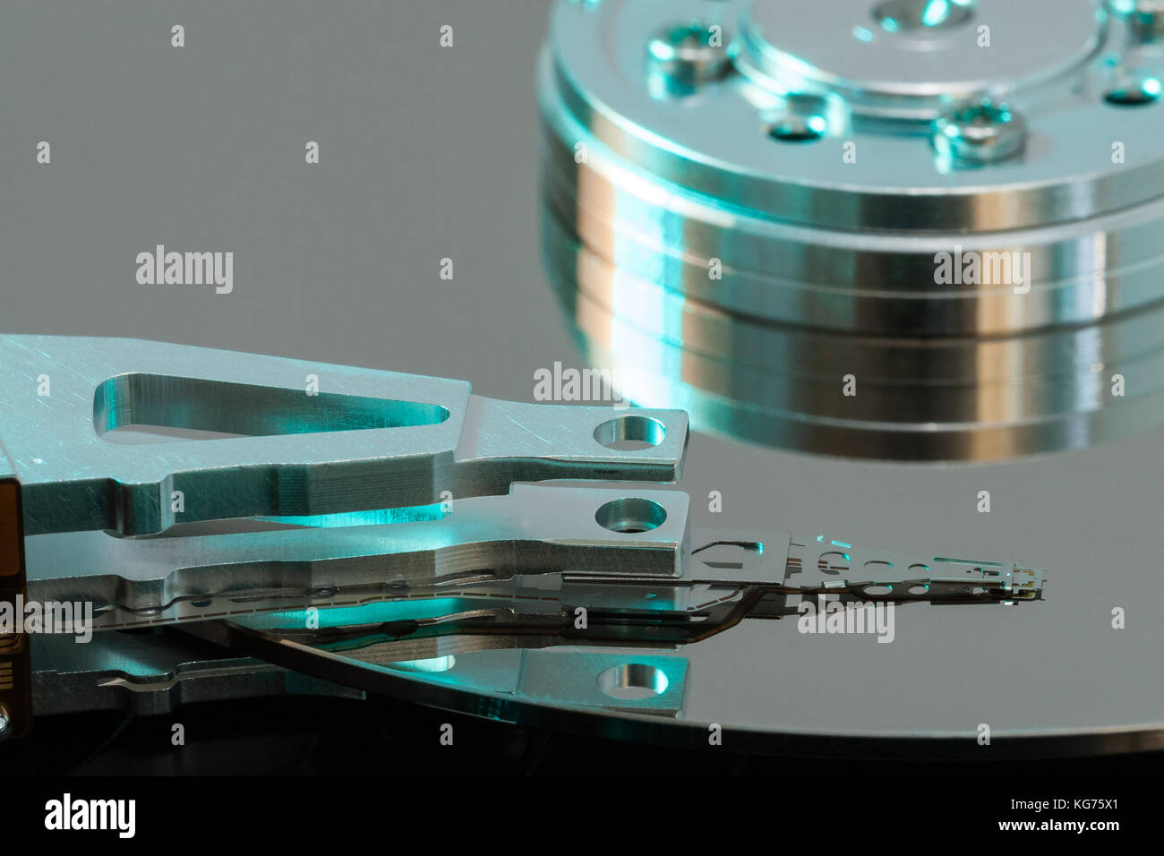 Close up inside of a computer harddrive with reflections of the read ...