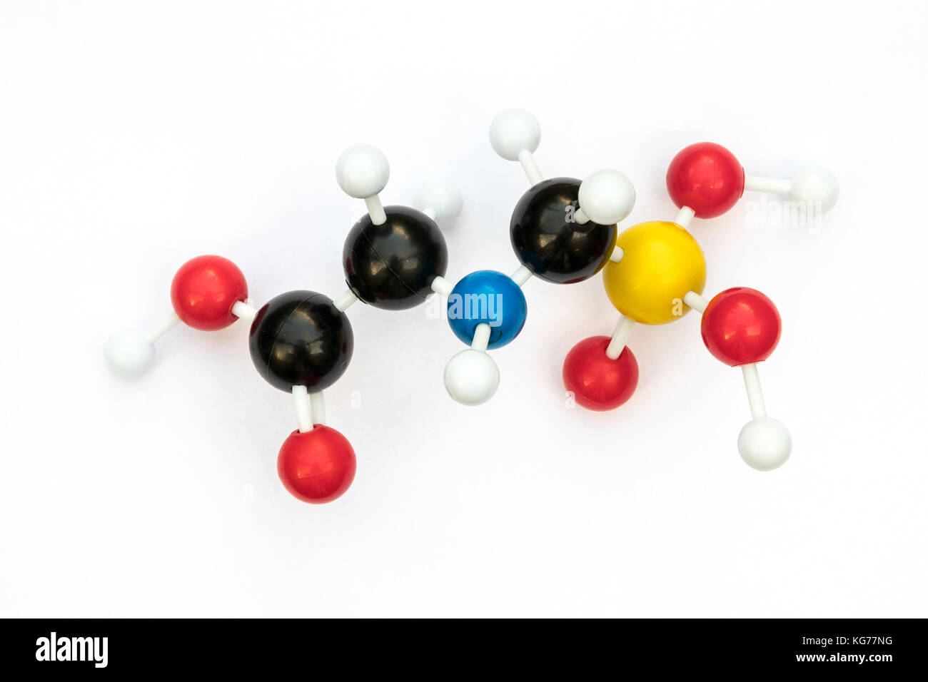 Plastic ball-and-stick model of the systemic herbicide glyphosate (chemical formula: C3H8NO5P) on a white background. Stock Photo