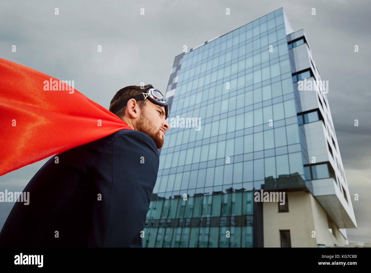 Businessman in a superman costume Stock Photo - Alamy