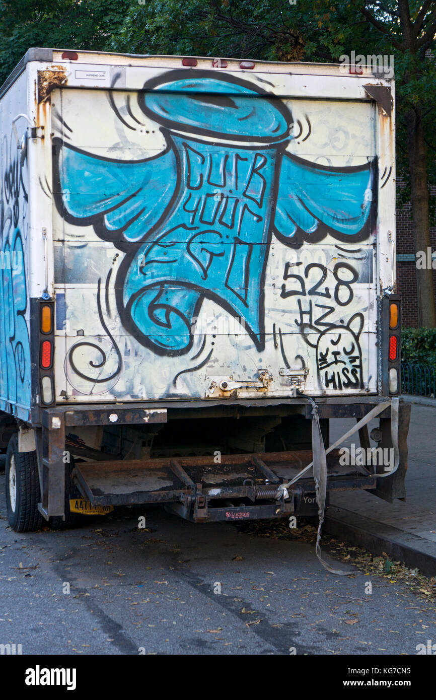 A truck parked in Chelsea with a painted sign advising to curb your ego. In Manhattan, New York City. Stock Photo
