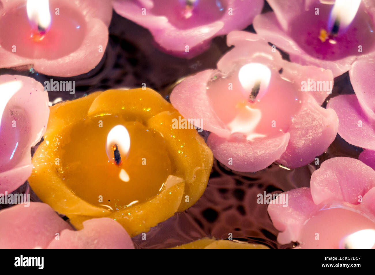 Beautiful floating candles lit and floating on a glass bowl of water