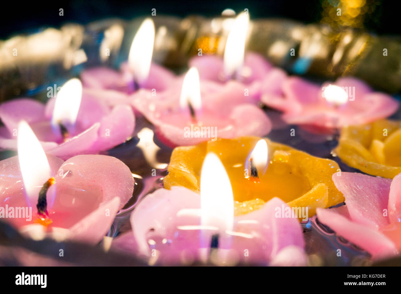 Beautiful floating candles lit and floating on a glass bowl of water