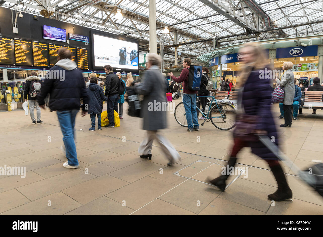 Commuters rush for their train during the rush hour at Edinburgh's Waverley Station. Stock Photo