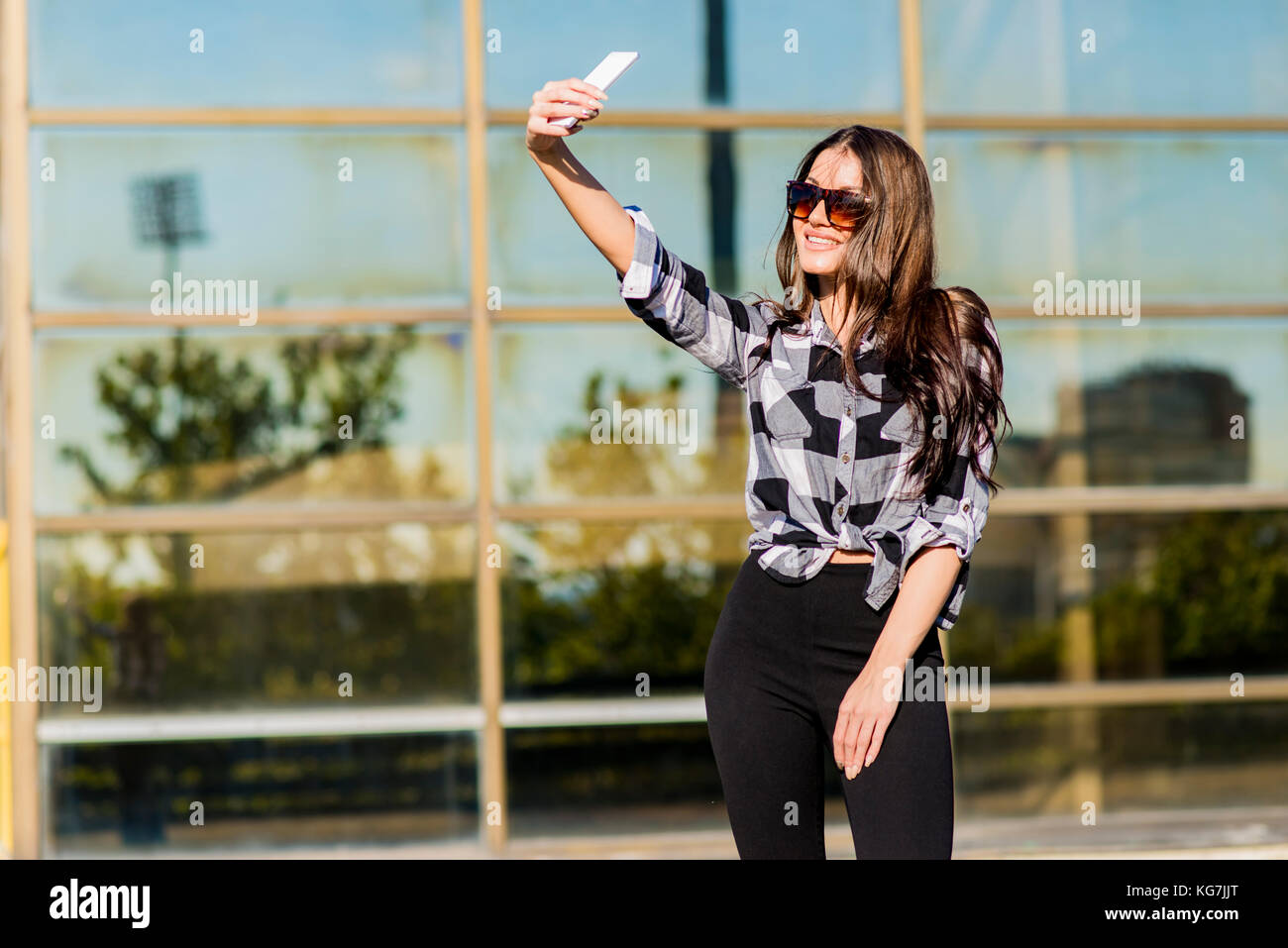 Attractive young woman taking selfie outdoor Stock Photo - Alamy