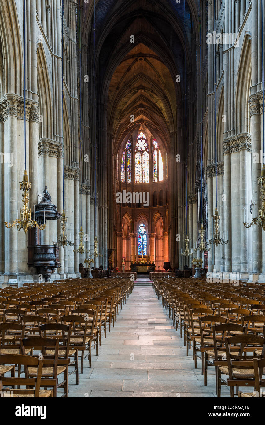 Reims, France - June 12, 2017: interior of the cathedral of Reims with many wooden chairs, high pillars and a pulpitt, France. Stock Photo