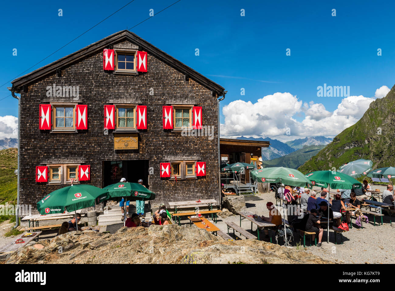 Tschaguns, Austria - July 17, 2017: People and hikers at the Wormser Hütte in the Montafon Alps on a summers day at the terrace of the restaurant, Aus Stock Photo