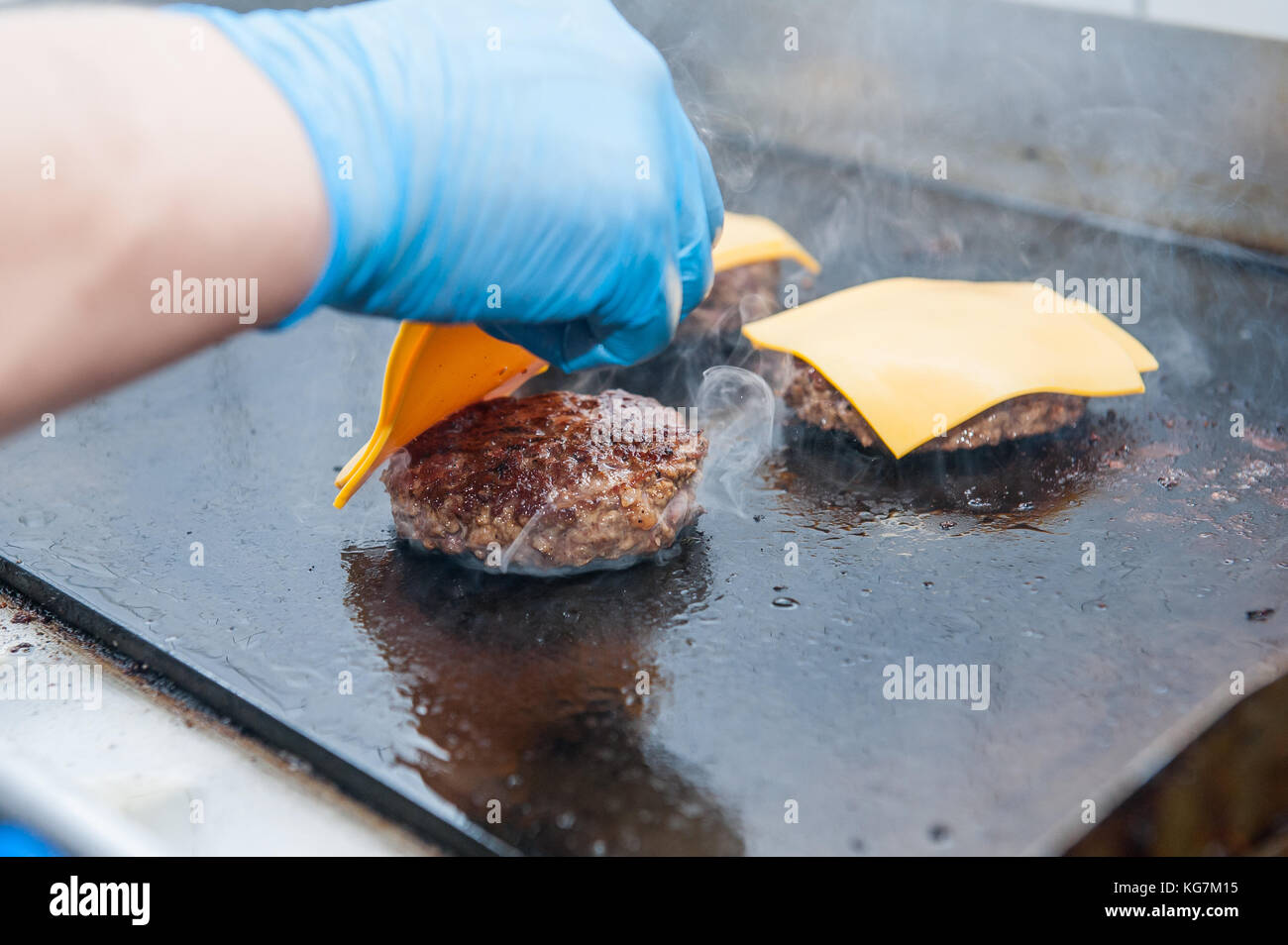 Chief cook preparing fresh burger in the kitchen.Burger restaurant menu