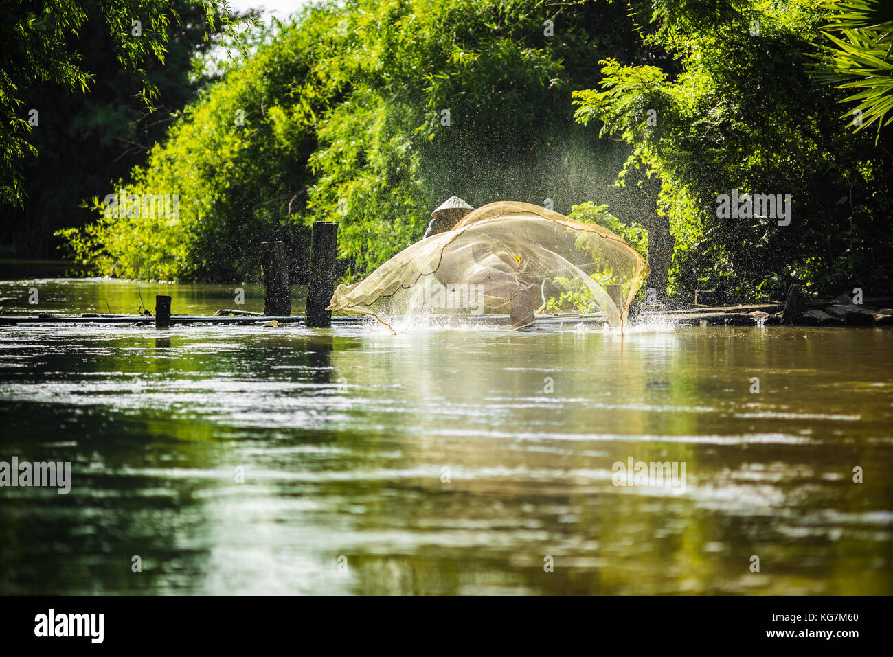 Asian Fishermen on wooden bridge fishing at river countryside,Asian