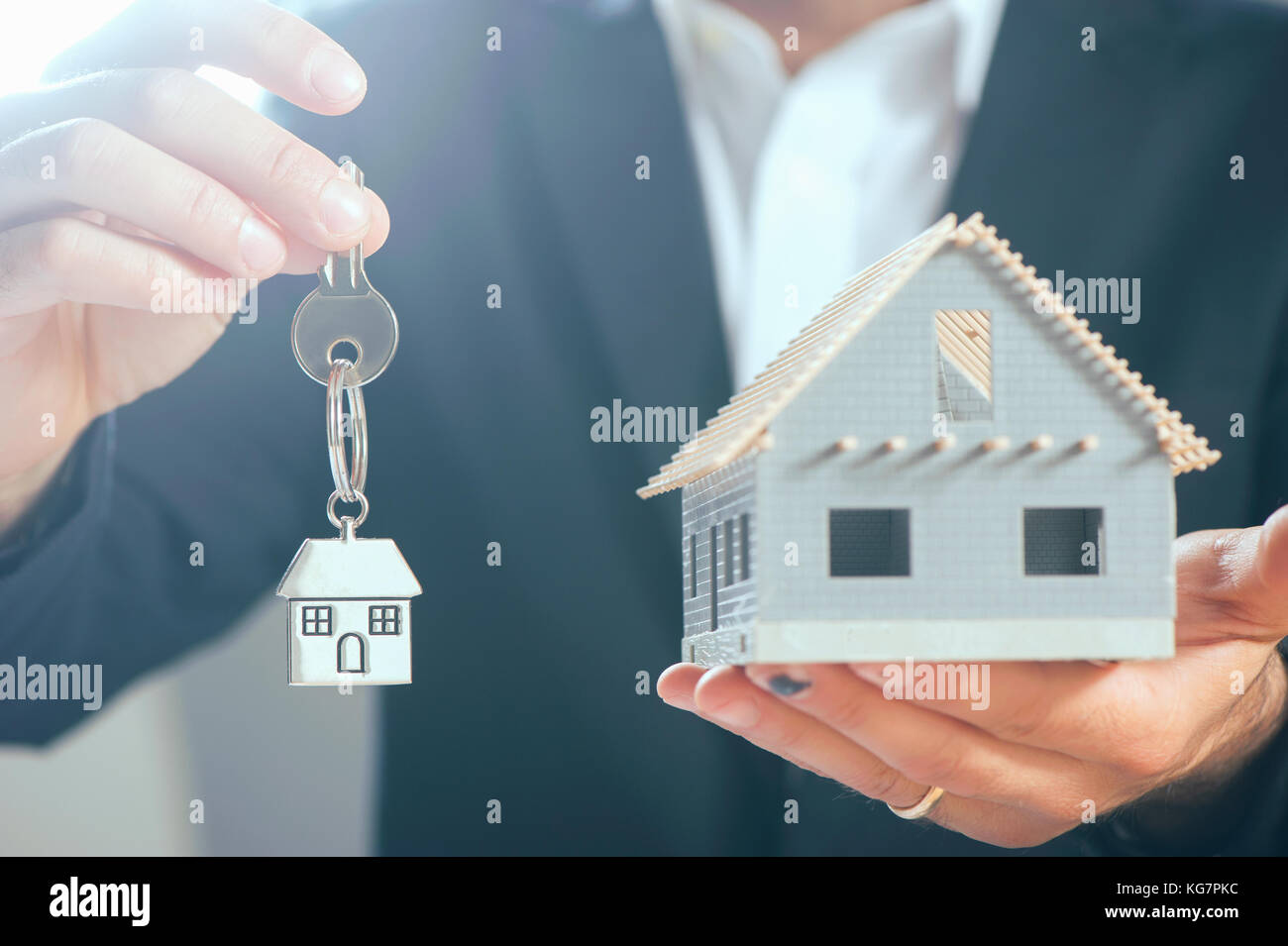House model in a palm of business man hand Stock Photo - Alamy