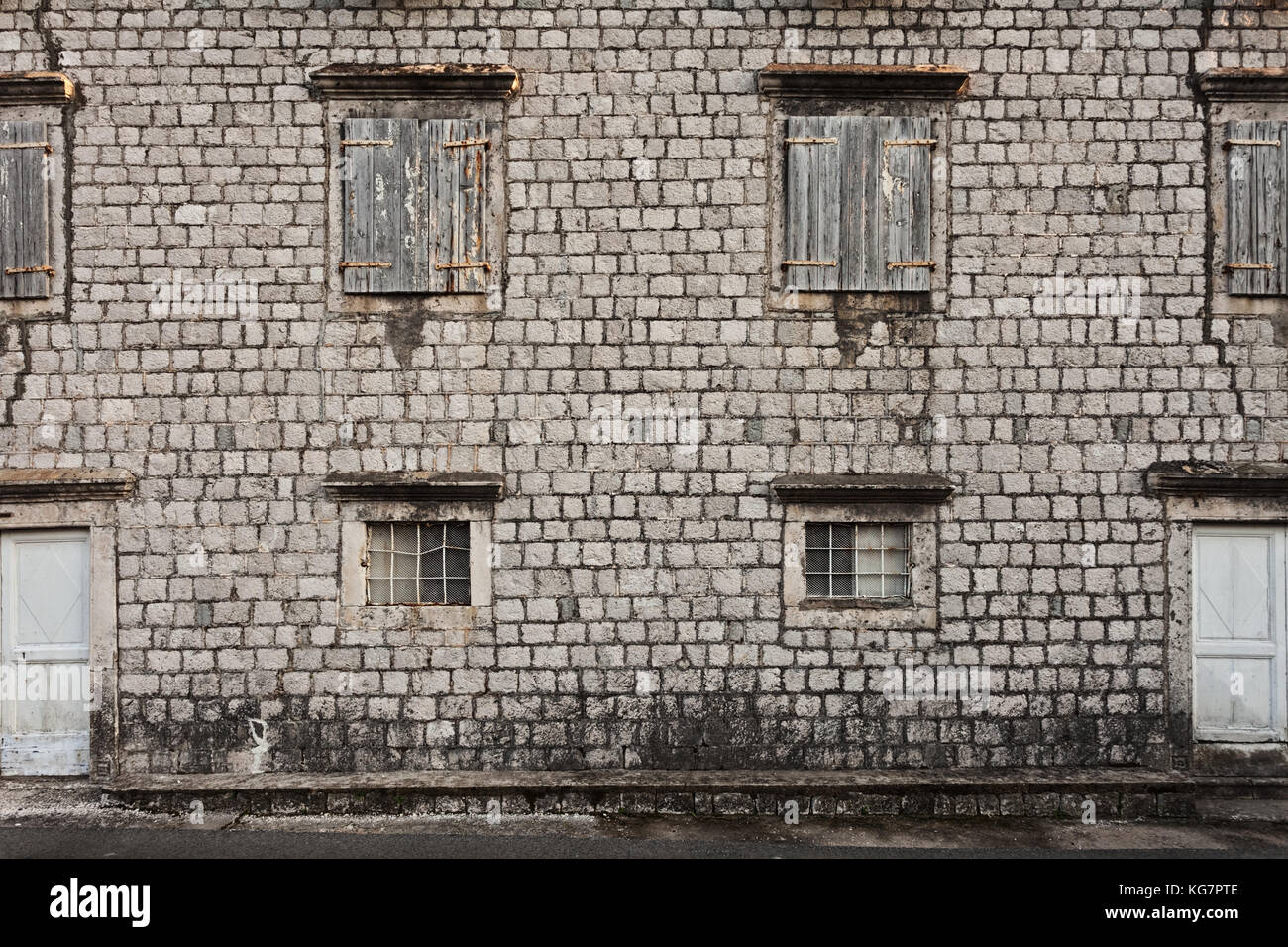 Old stones wall with doors and windows Stock Photo - Alamy