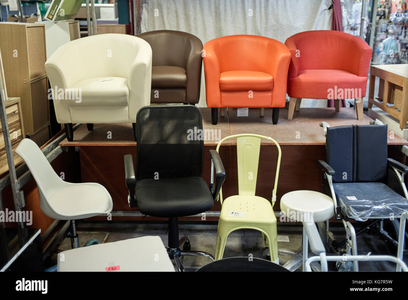 Seats for sale in an indoor market Stock Photo