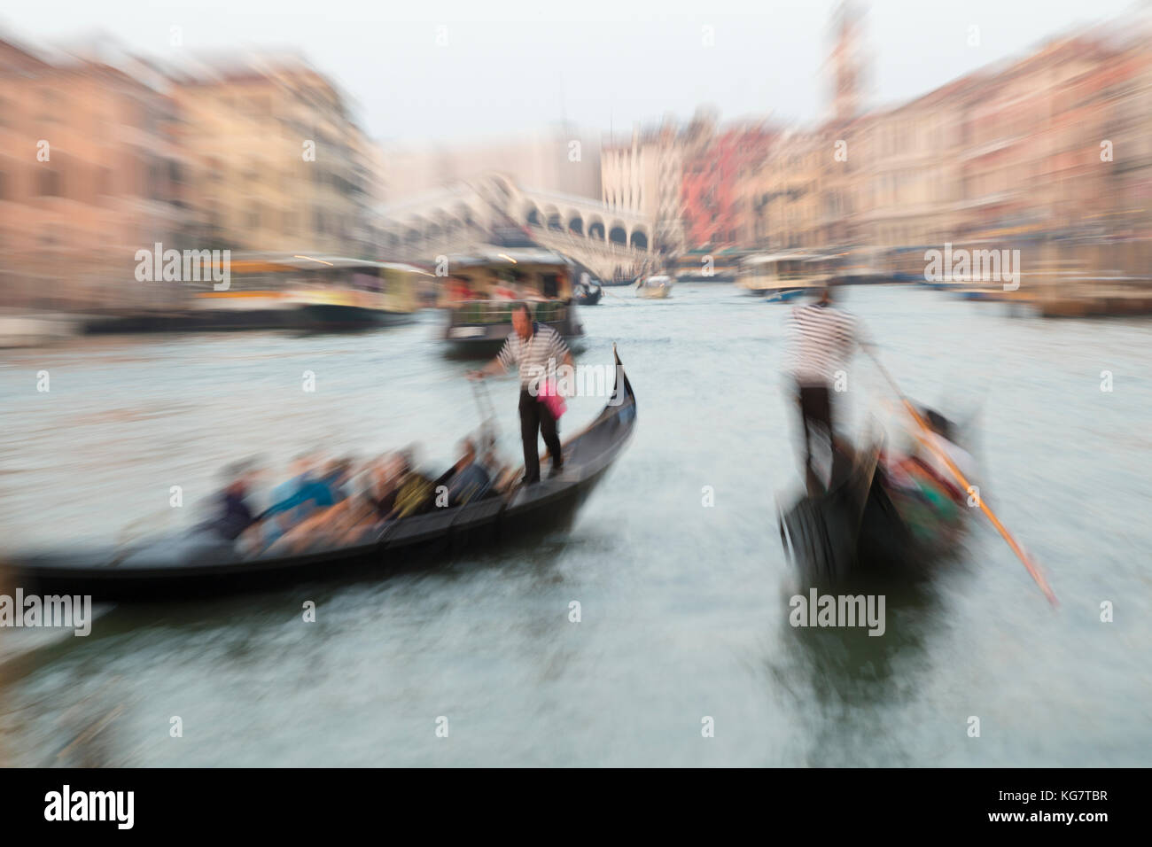 Italy, Venice, zoomed view of gondolers on the Grand Canal and the Rialto bridge. Stock Photo