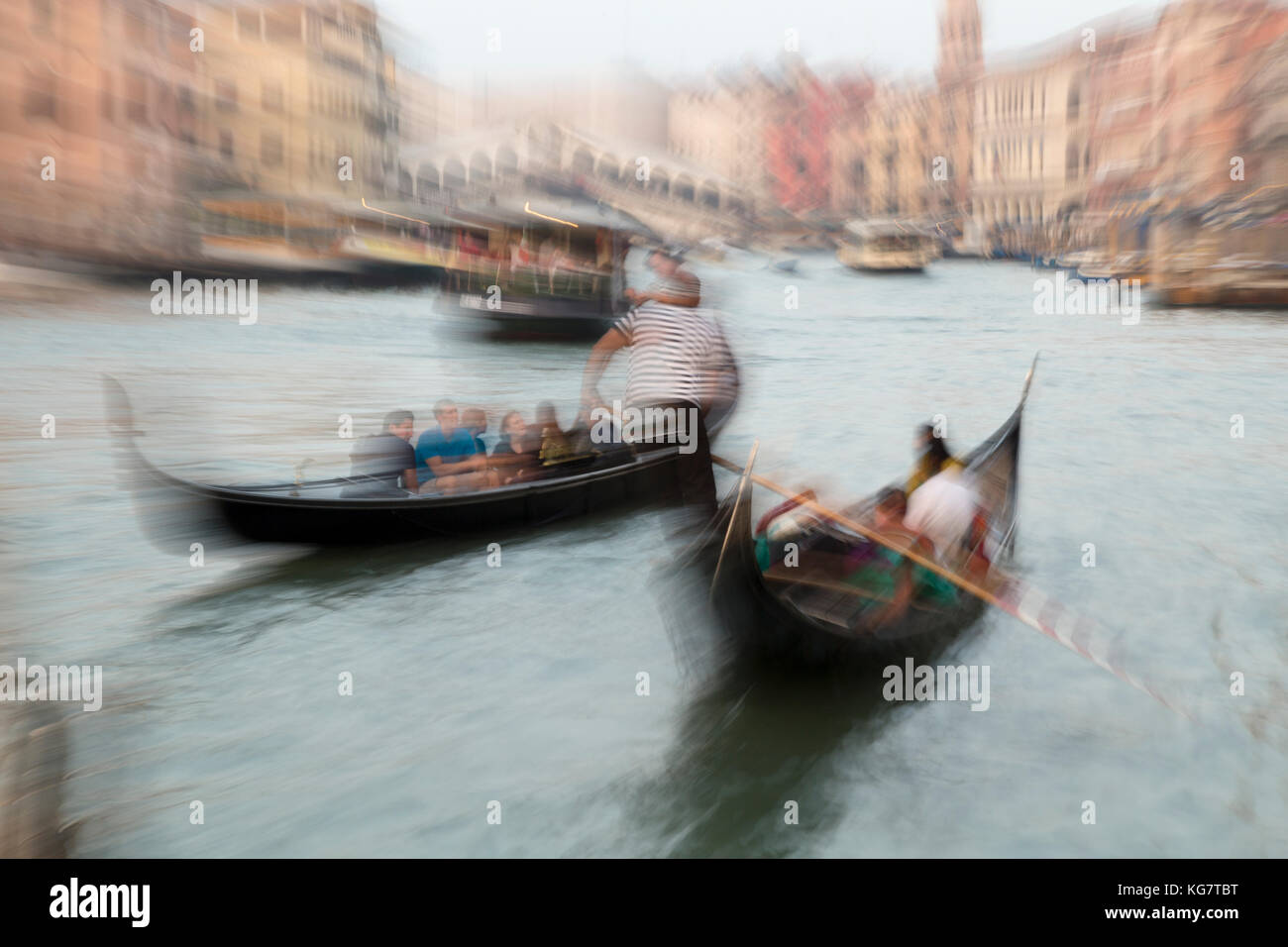 Italy, Venice, zoomed view of gondolers on the Grand Canal and the Rialto bridge. Stock Photo
