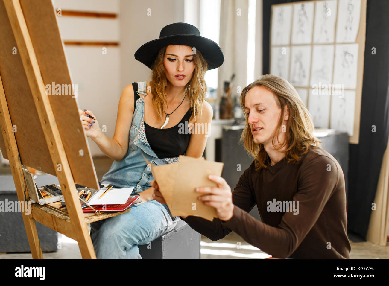 Artist Consult his Colleague while Drawing Stock Photo