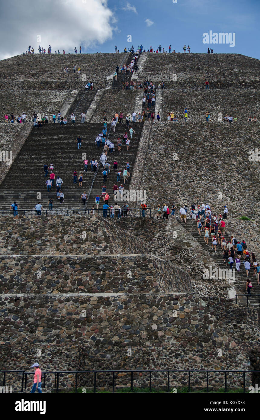 Hundreds of tourists climb the stairs of the Pyramid of the Sun in