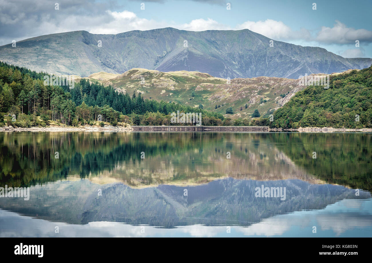 Dramatic hill formations reflect in the still waters of Thirlmere in the Lake District Stock Photo