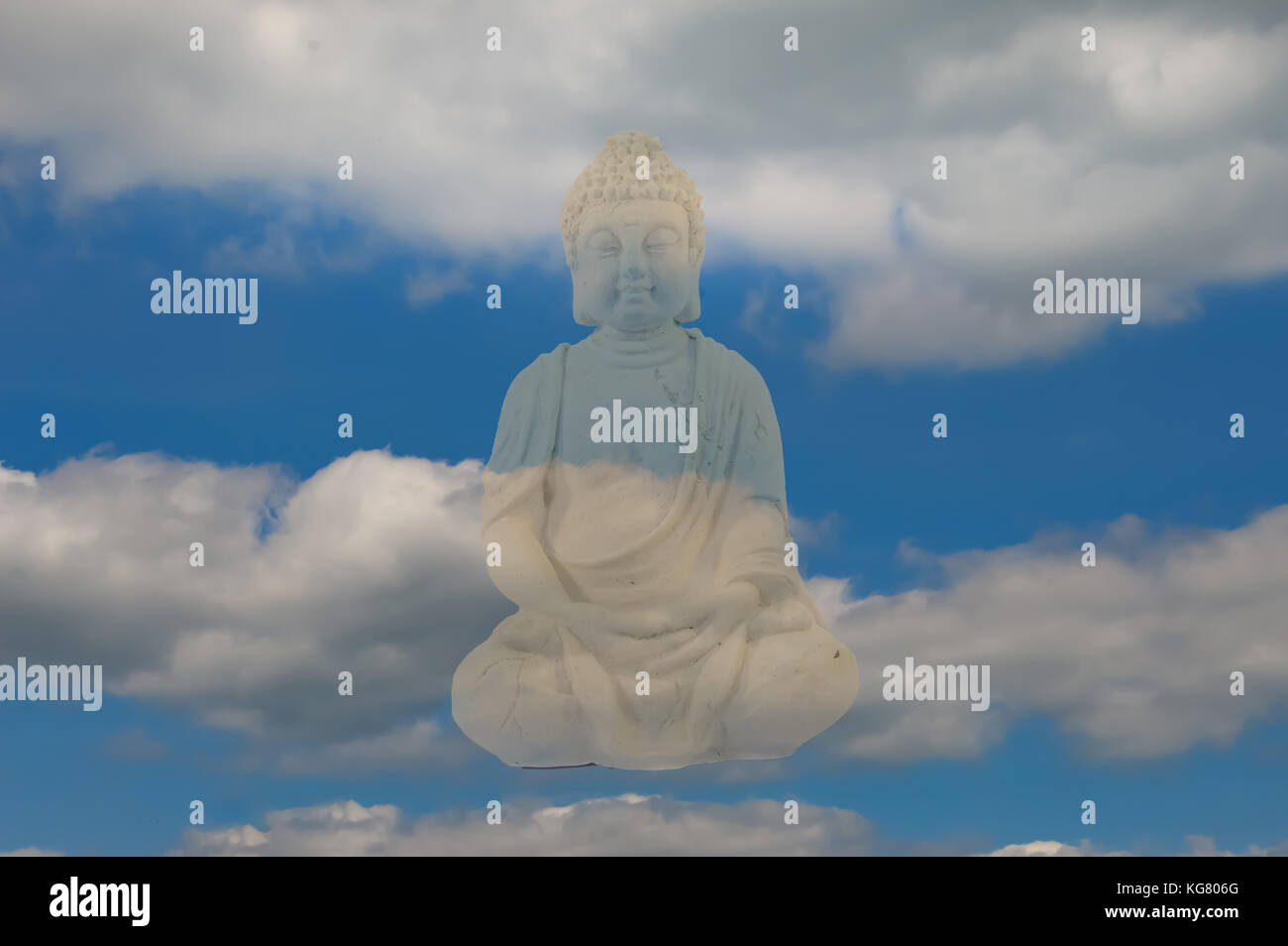 Stone Buddha statue on a blue sky and cloud background Stock Photo - Alamy