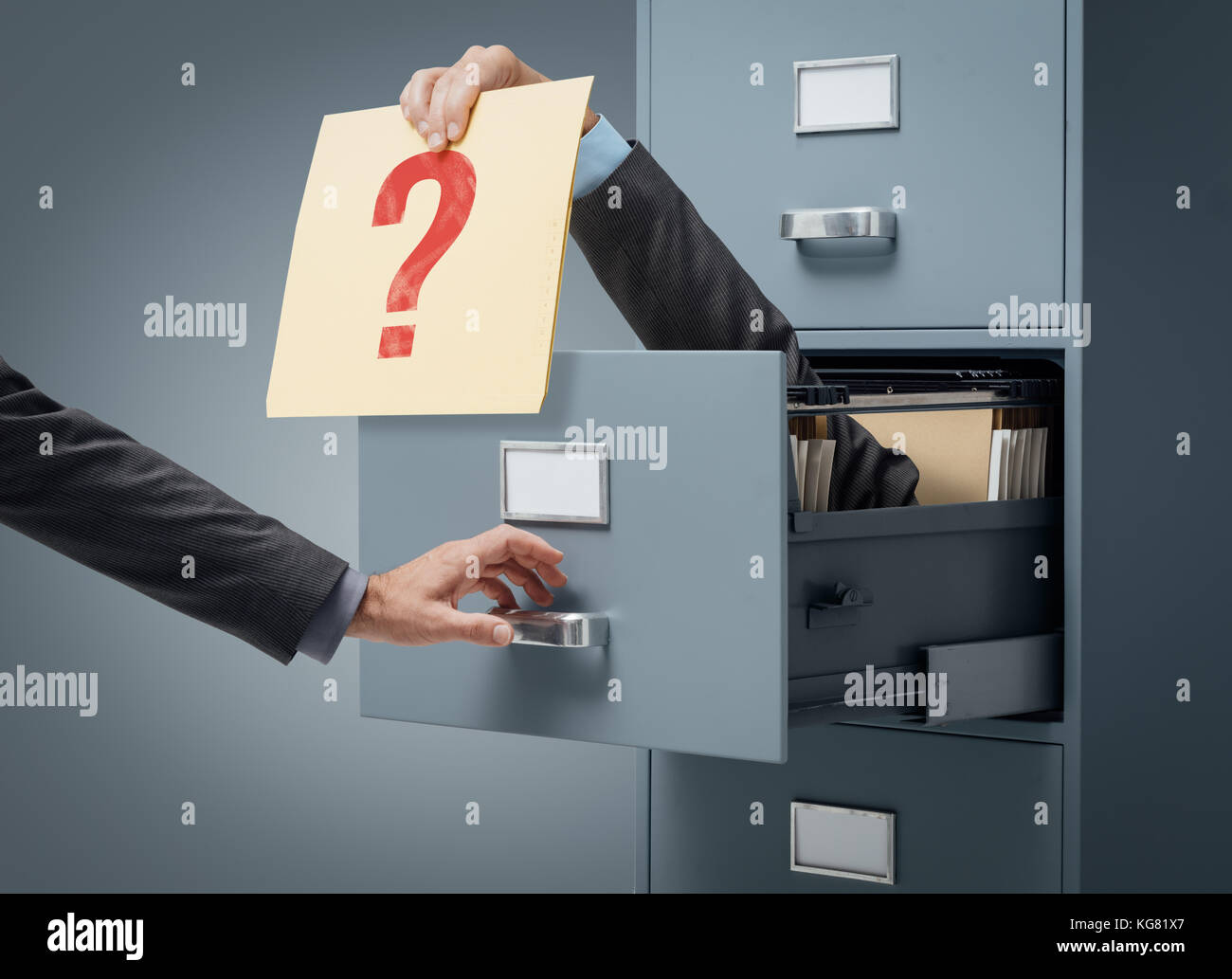Businessman inside a filing cabinet giving a file with a question mark ...