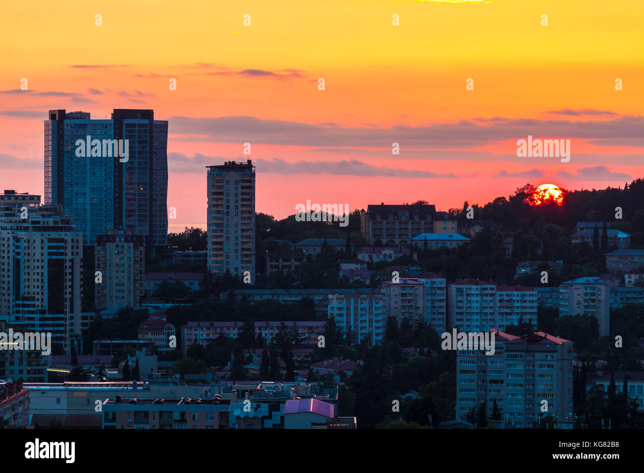 Aerial view of the Sochi city on the background of the setting sun and ...