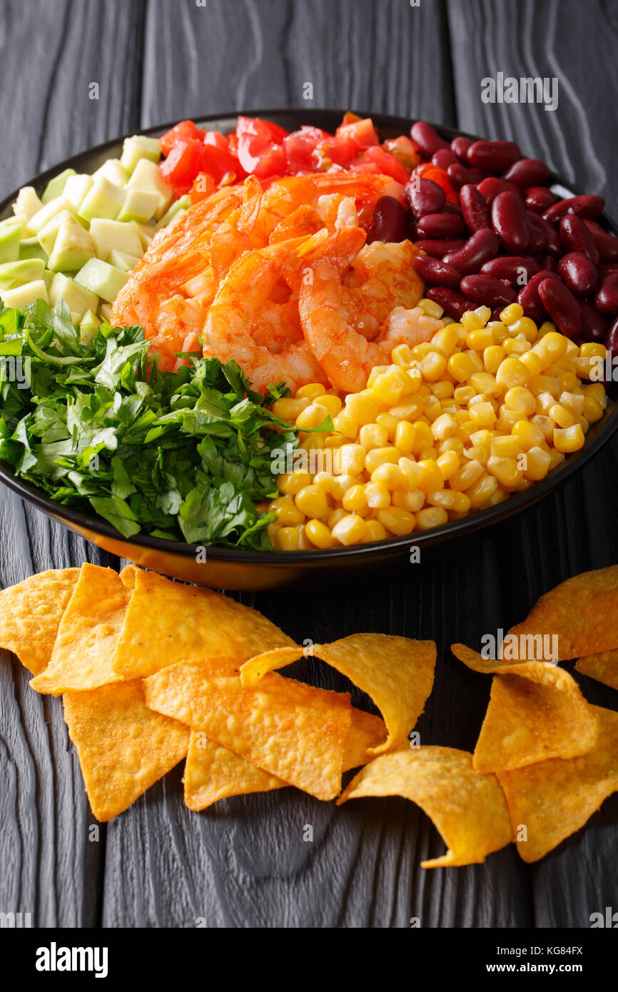 Mexican food: burrito bowl with prawns and vegetables close-up on the table. vertical Stock Photo