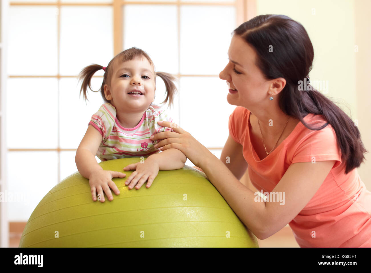 Baby exercises on the fitball Stock Photo