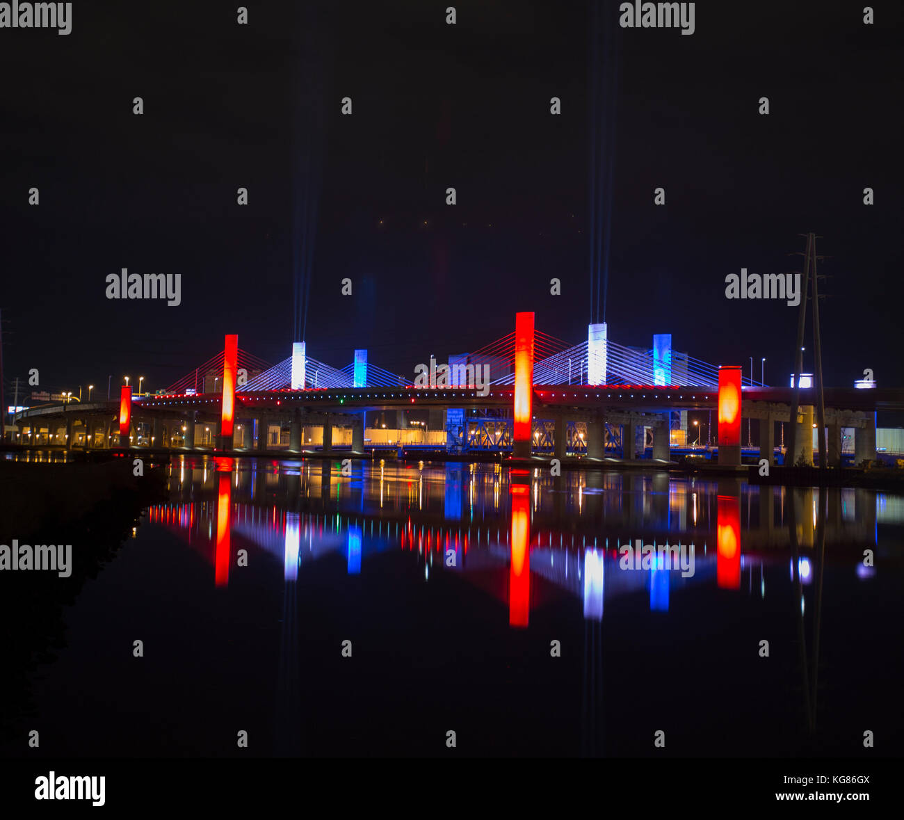 Lights from the Pearl Harbor Memorial Bridge in New Haven, Connecticut reflect in the Quinnipiac RIver on Pearl Harbor Day 2016. Stock Photo
