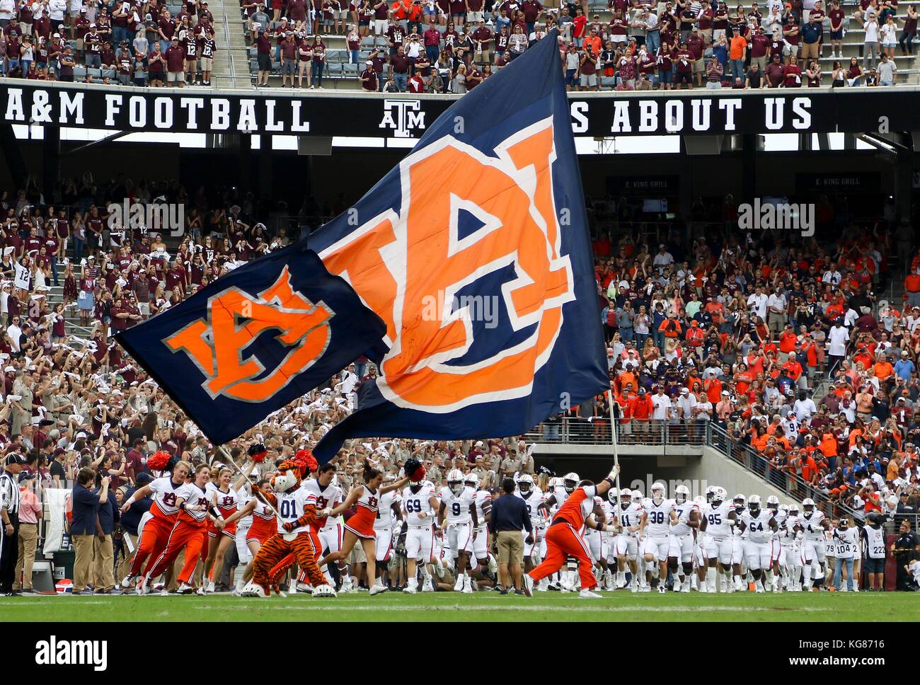 November 4, 2017: Auburn Tigers cheerleaders and mascot runout with the flags at the start of the game against the Texas A&M Aggies during the NCAA football game between the Auburn Tigers and the Texas A&M Aggies at Kyle Field in College Station, TX; John Glaser/CSM. Stock Photo