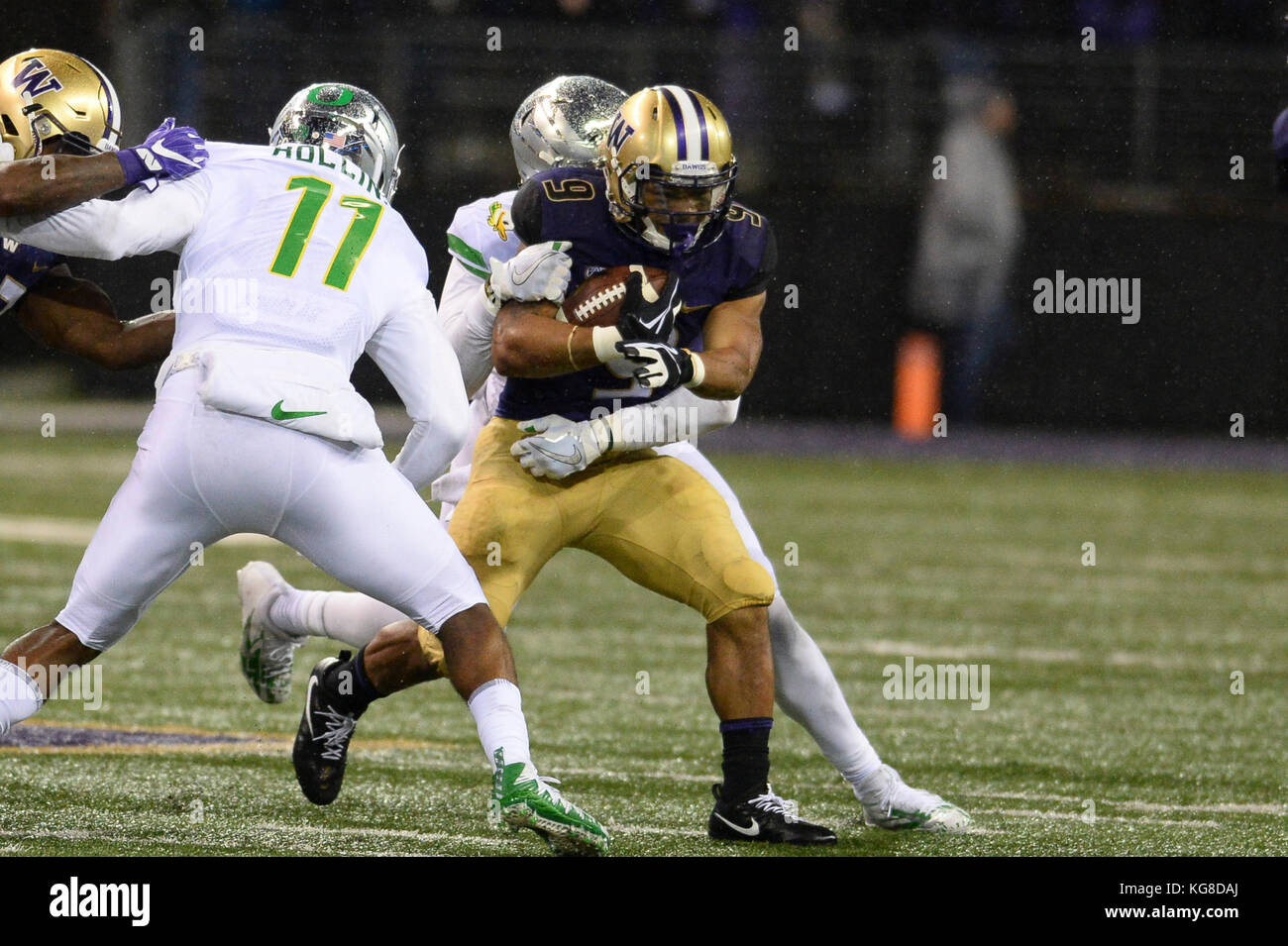 Seattle, WA, USA. 4th Nov, 2017. UW tailback Myles Gaskin (9) picks up yardage against the Oregon defense in a PAC12 football game between the Oregon Ducks and the Washington Huskies. The game was played at Husky Stadium on the University of Washington campus in Seattle, WA. Jeff Halstead/CSM/Alamy Live News Stock Photo