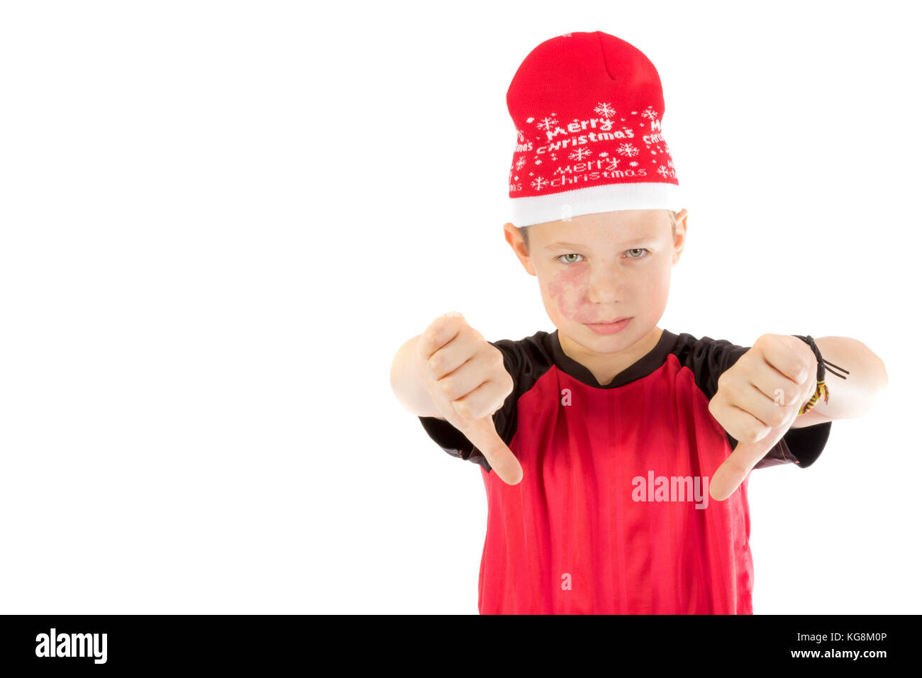 Pre-teen boy wearing a santa hat looking unhappy isolated on white Stock Photo