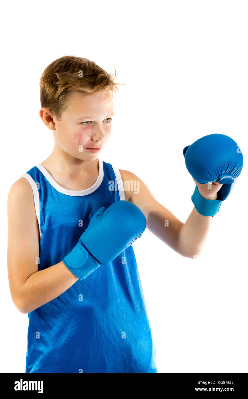 Preteen boxer boy with boxing gloves isolated against a white Stock