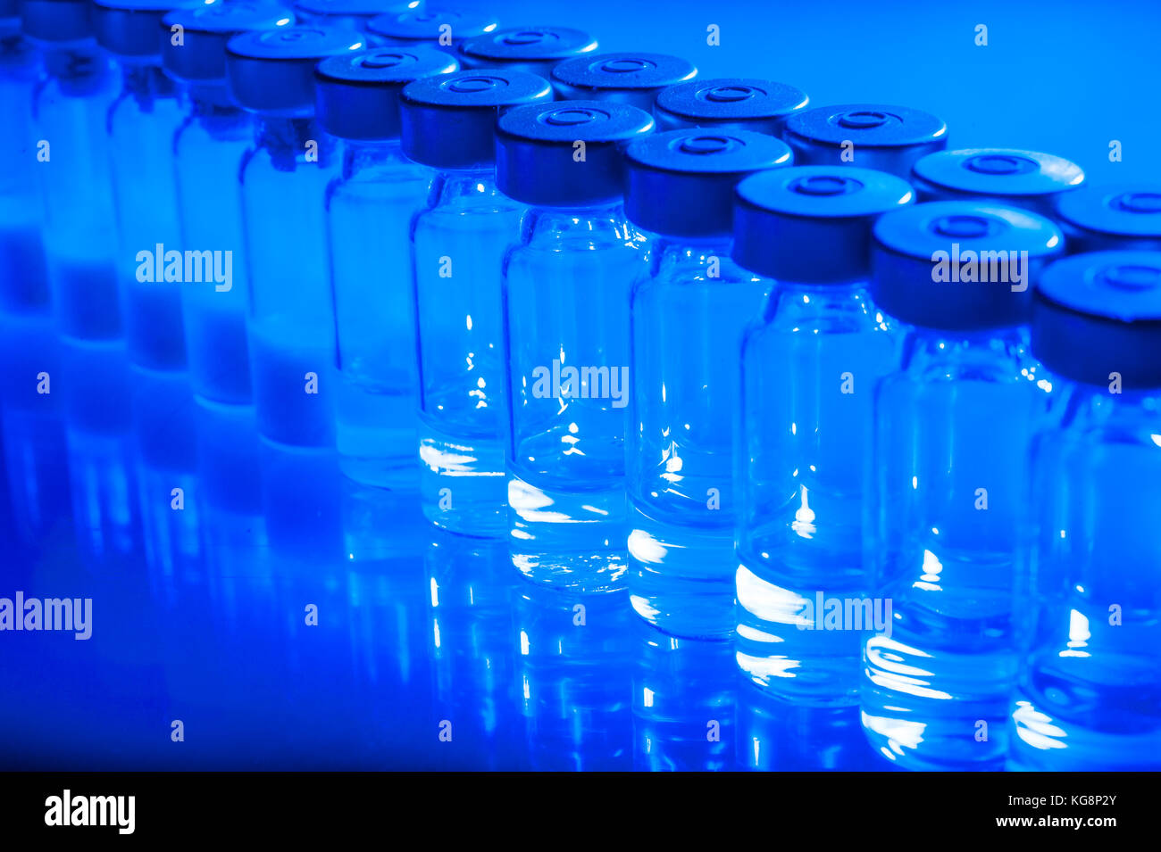 Vials of the vaccine, blue background Stock Photo - Alamy