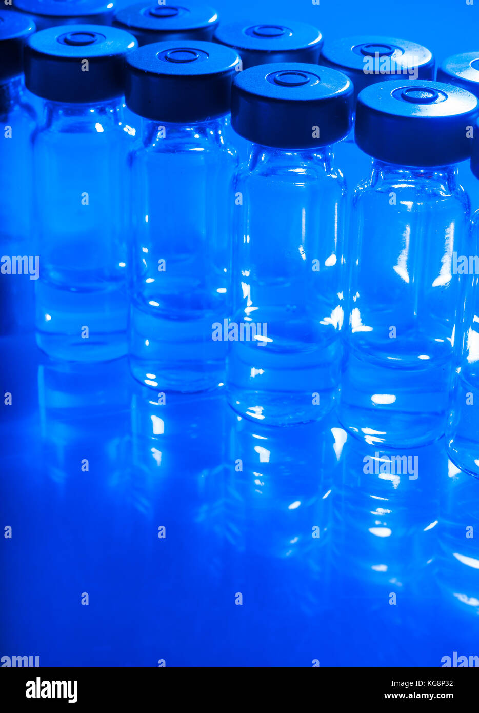 Vials of the vaccine, blue background Stock Photo - Alamy