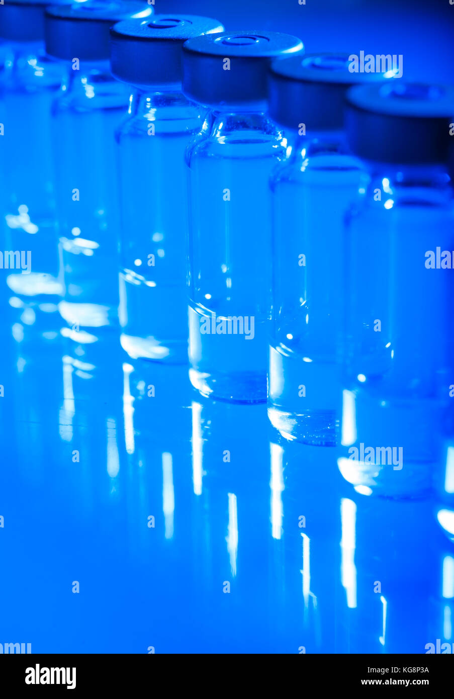 Vials of the vaccine, blue background Stock Photo - Alamy