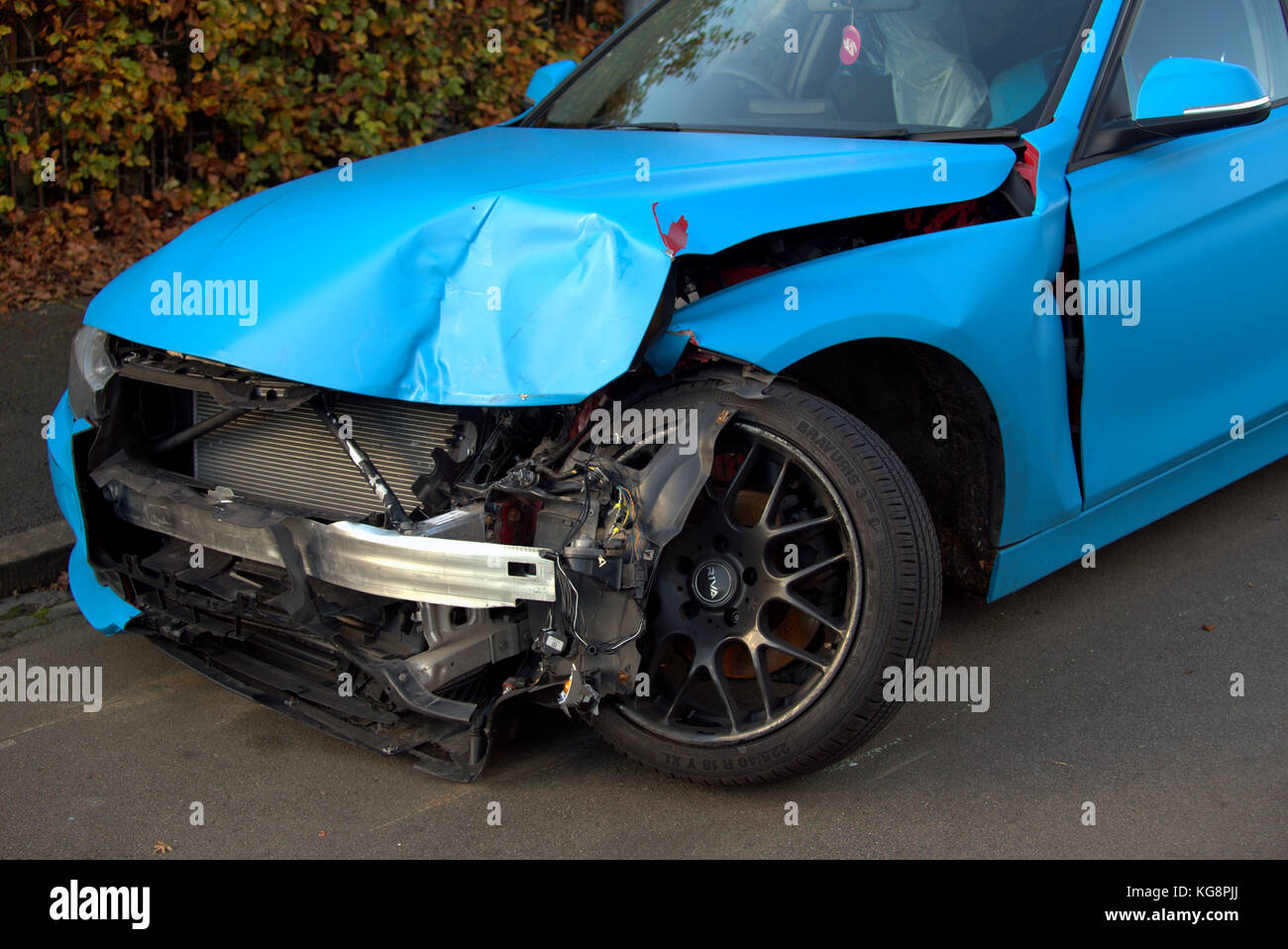 car crash car damaged front wheel at right angle Stock Photo