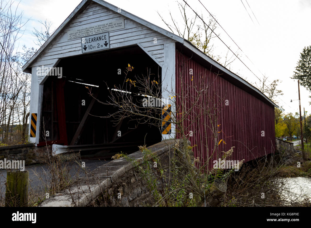 Mifflinburg, PA - November 4, 2017: The Hassenplug Bridge spans Buffalo Creek, and at 80 feet long, in one of the oldest wooden covered bridges in the Stock Photo
