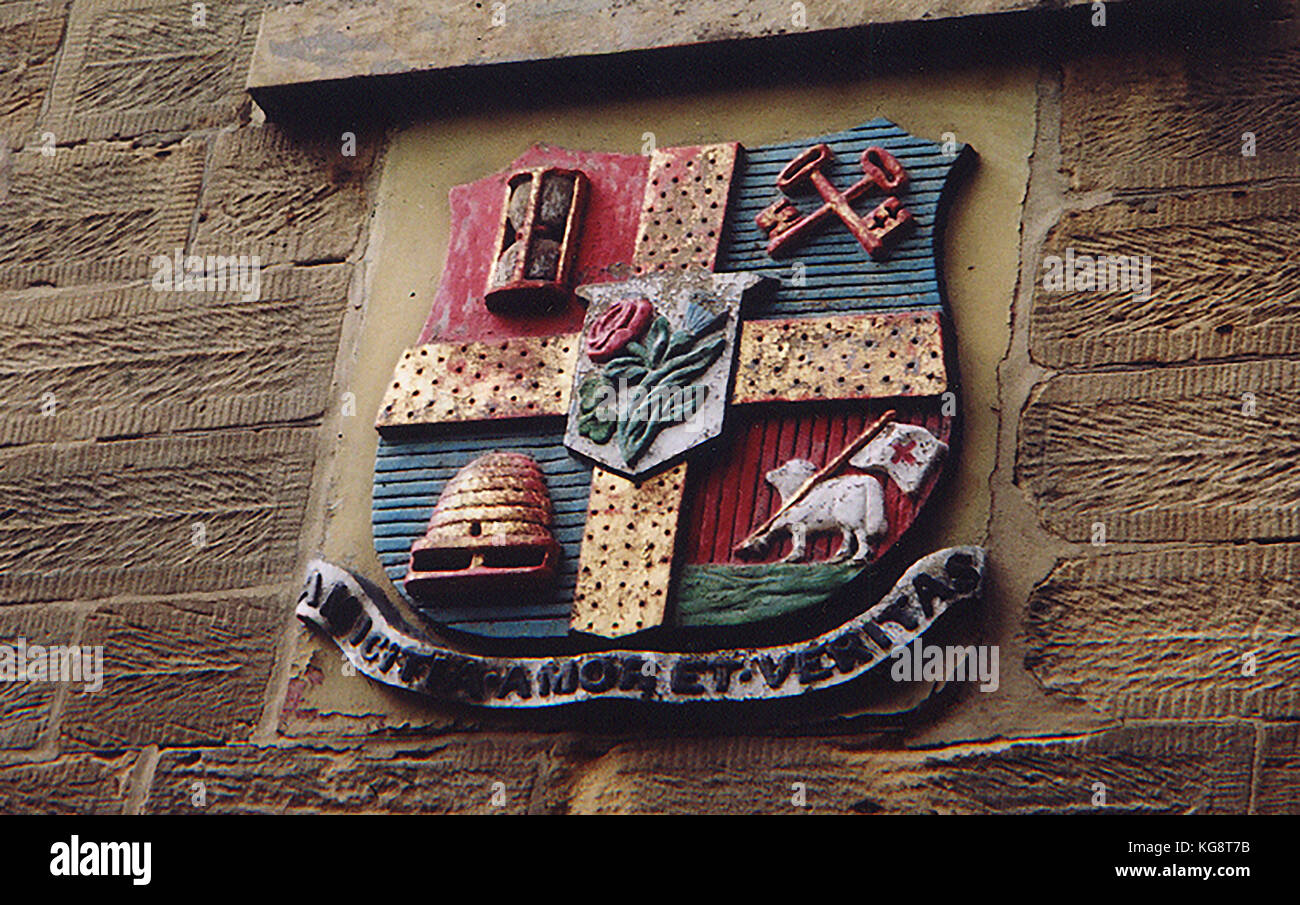 Symbolic plaque indicating a branch of the Independent Order Odd Fellows on a UK  village wall st Robin Hood's Bay, Yorkshire Stock Photo