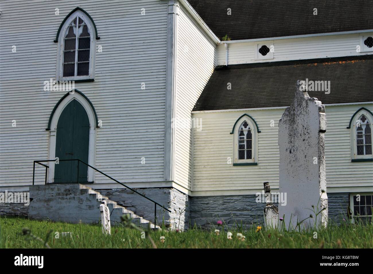 The old cemetery and St. George's Church, Brigus, Newfoundland and Labrador. Partial View of old headstones and church. Stock Photo