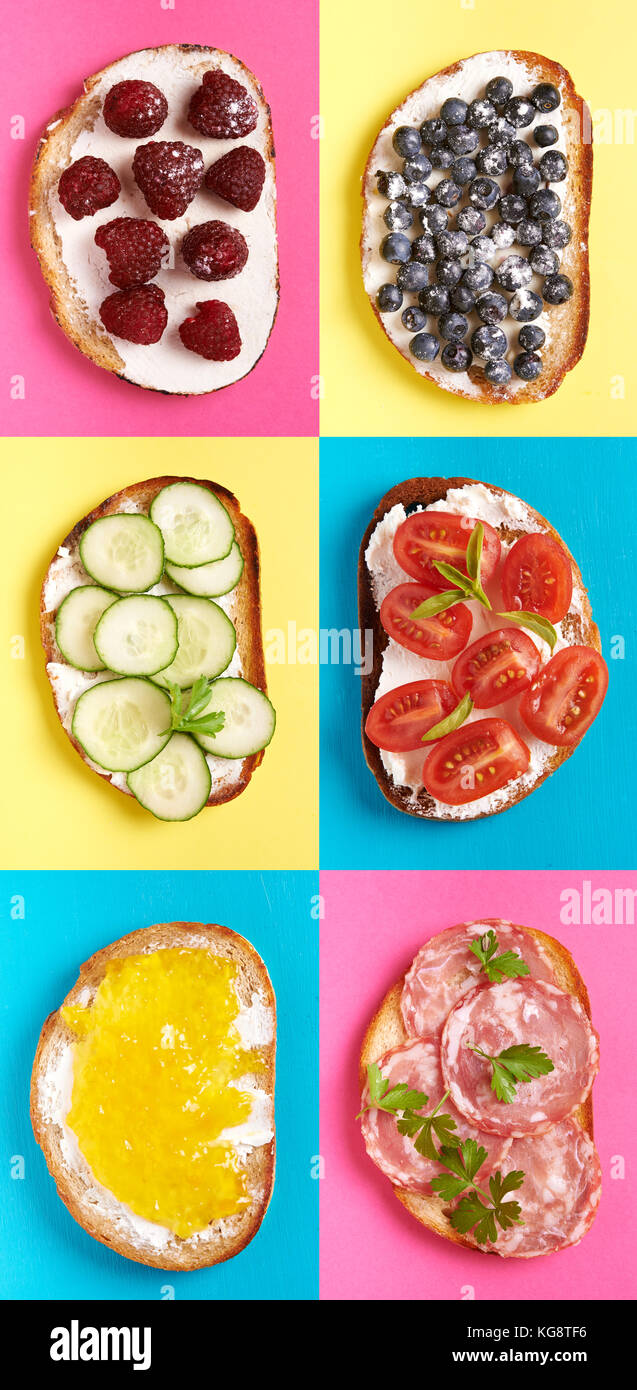 sweet and savory toast isoletd on white background. cheese, cucumber, tomatoes, salami, banana, strawberries, blueberries and fruits jam Stock Photo