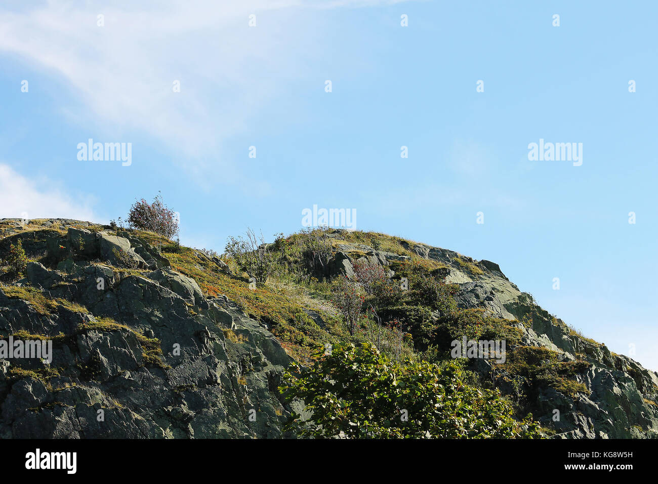 Rocky hilltop, Signal Hill, St. John's Newfoundland and Labrador. Blue sky with light cloud. Stock Photo